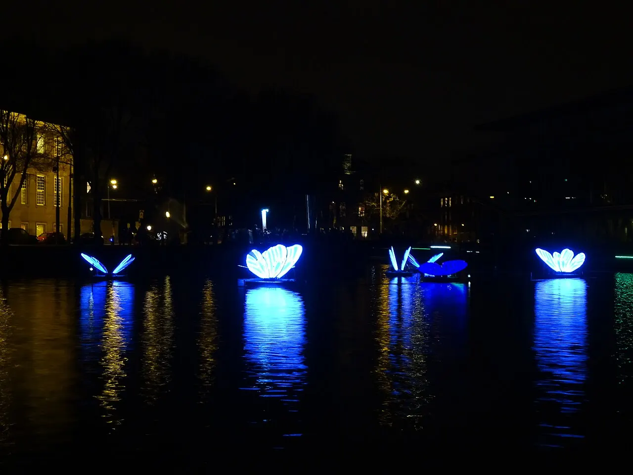 Glowing light-art installation on a canal during the Amsterdam Light Festival
