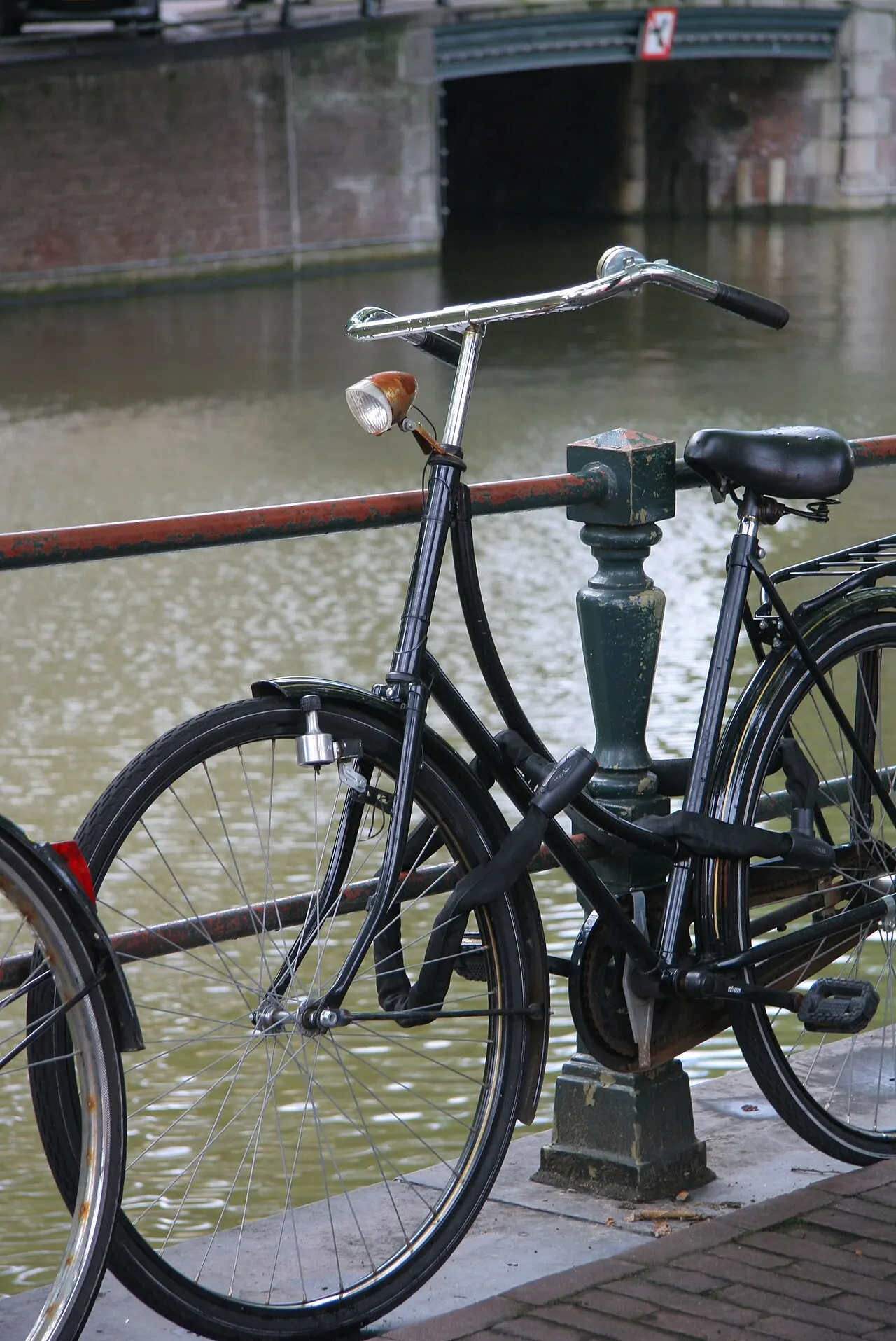 A classic Dutch bicycle parked by an Amsterdam canal