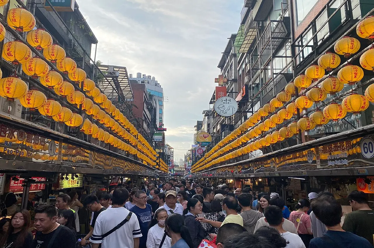 Rows of yellow lanterns over the food stalls at Keelung Miaokou Night Market