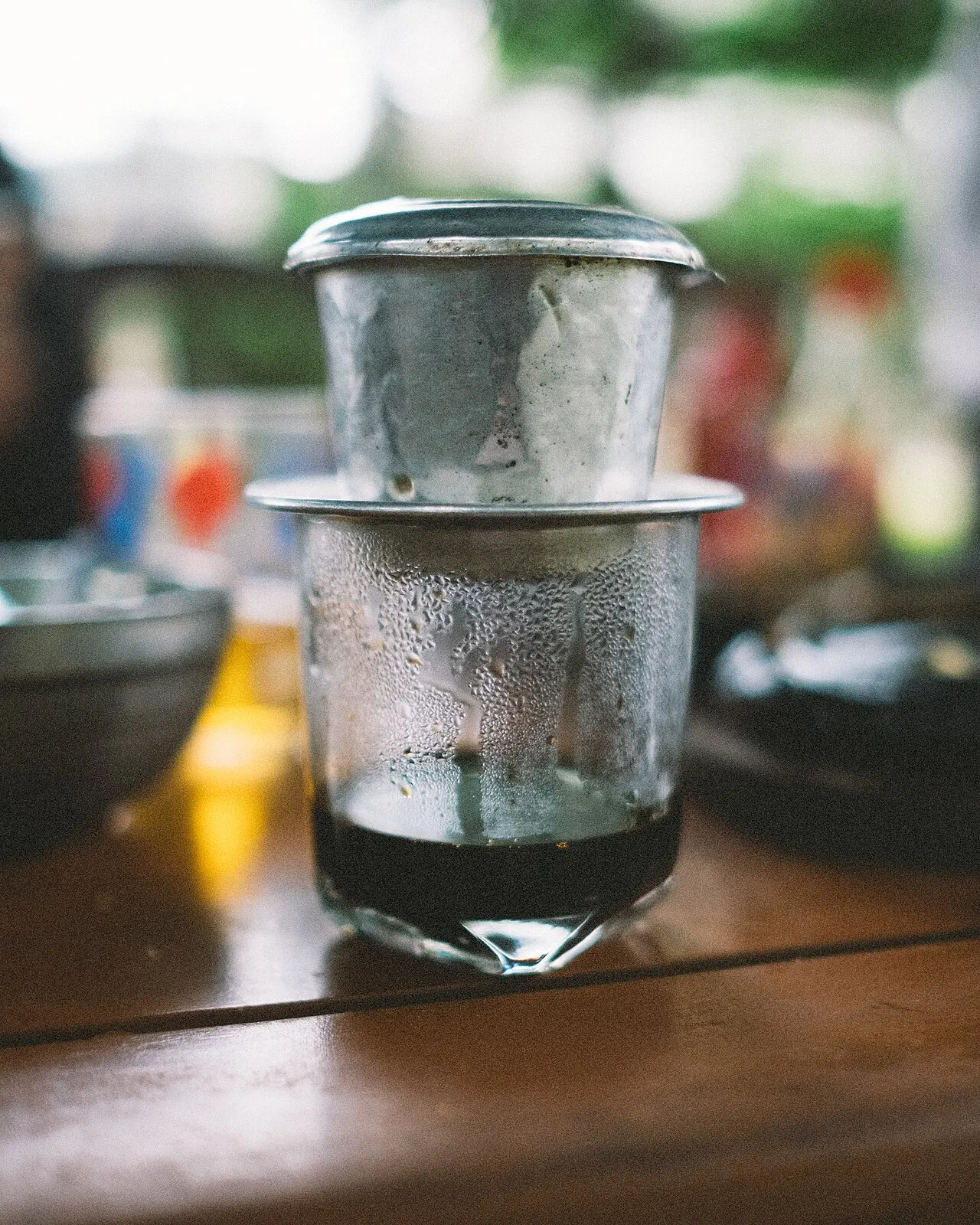 Vietnamese coffee dripping through a phin filter