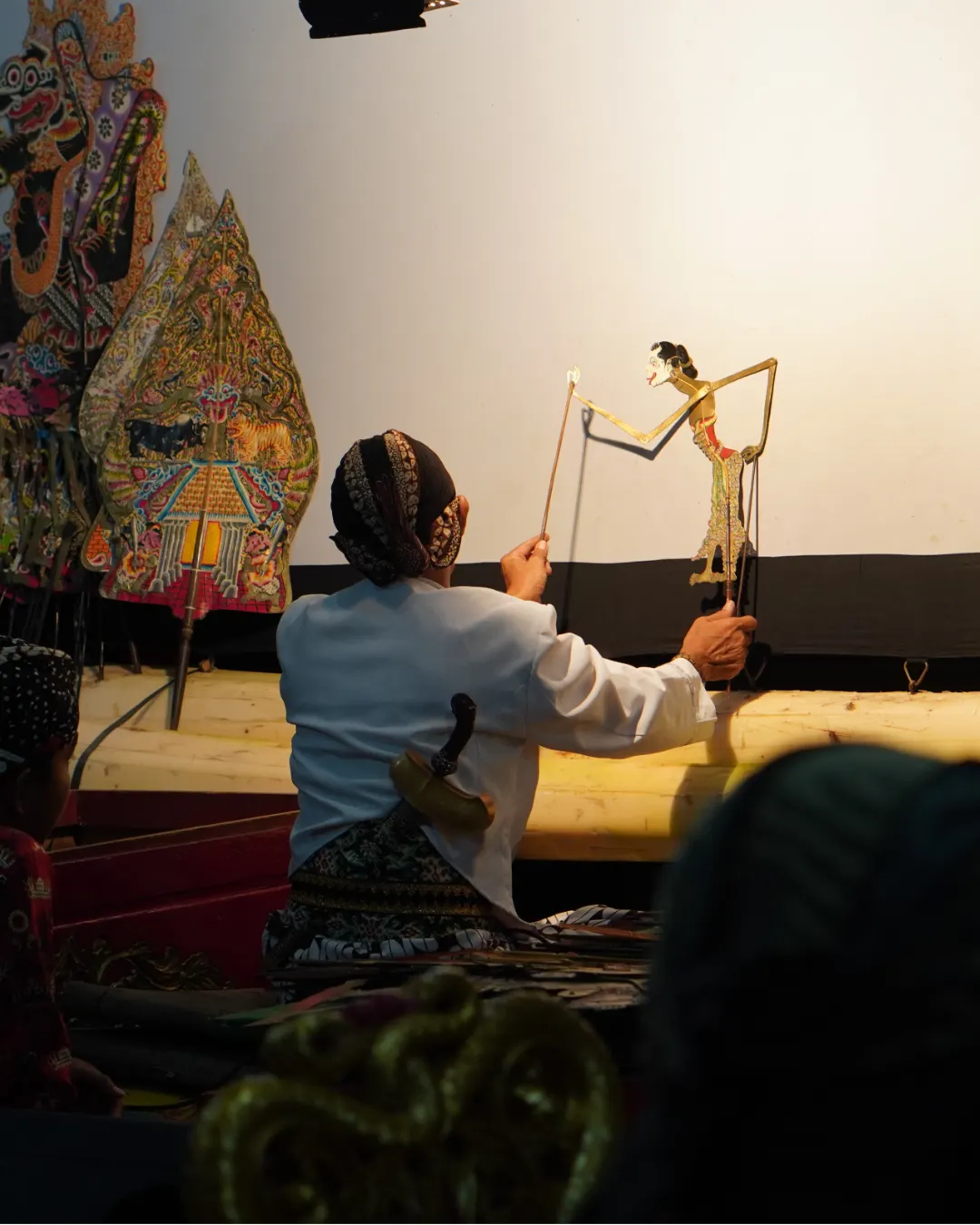 A dalang performing wayang kulit shadow puppetry