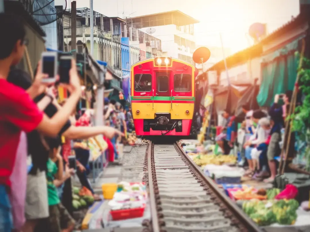 Train passing through Maeklong Railway Market