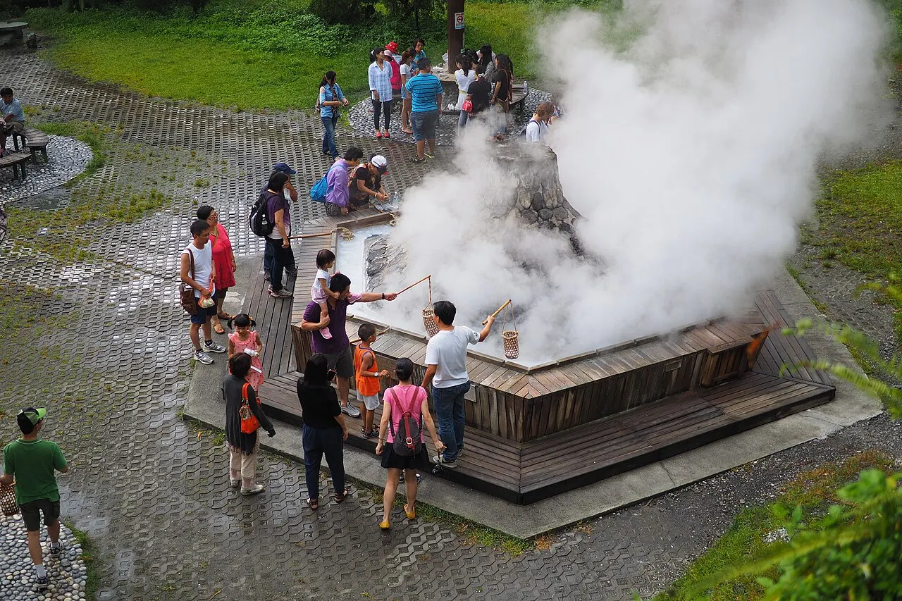 Visitors boiling eggs in the steaming pool at Jiuzhize Hot Spring, Yilan