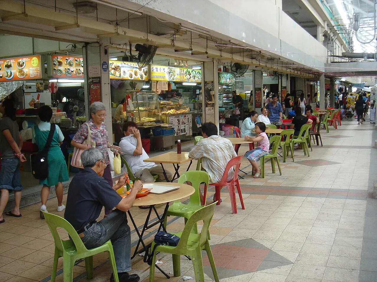 A Singapore kopitiam (coffee shop) with locals at plastic tables
