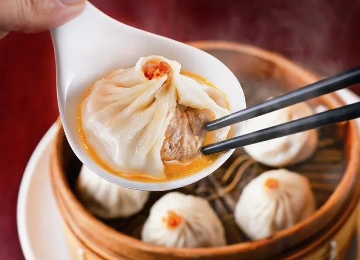Xiaolongbao soup dumplings in a bamboo steamer