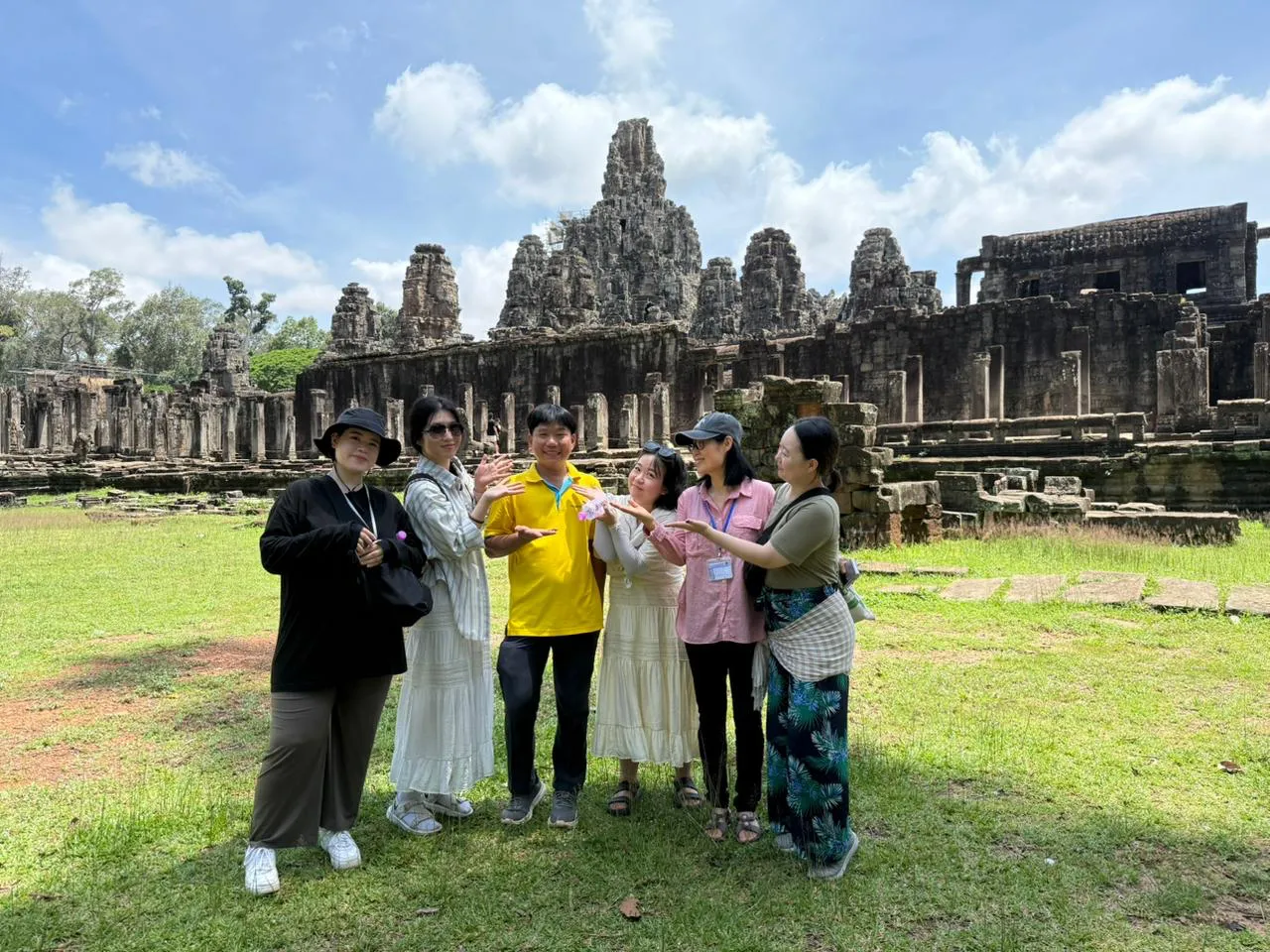 A MyProGuide guide with travellers in front of Bayon Temple, Angkor, Cambodia